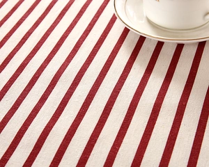 Close-up of red and white striped table runner fabric with coarse woven texture