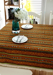 Detail of bohemian geometric striped tablecloth with beige lace edge and cotton linen texture