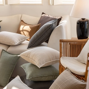 Minimalist checkered polyester cushion cover in solid colors with natural sunlight detail