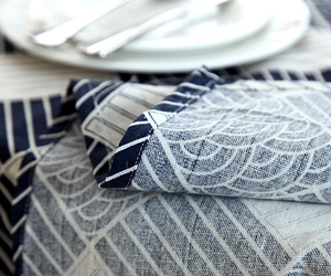 Detail of navy and cream geometric pattern cotton linen tablecloth with wave lace edge