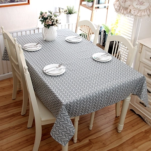 Modern rectangular tablecloth featuring grey and white herringbone pattern in dining setting