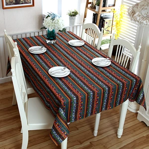 Detail view of colorful striped linen tablecloth with ethnic patterns and lace trim decoration