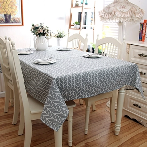 Close-up of modern grey tablecloth with white herringbone geometric pattern on dining table