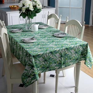 Detail of thick cotton canvas tablecloth with tropical green palm leaf pattern prints