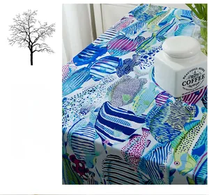 Close-up of thick cotton tablecloth with colorful tropical blue and purple fish pattern