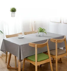 Macro shot of waterproof grey linen texture fabric on a modern rectangle wooden dining table