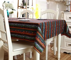 Close-up of Bohemian striped linen tablecloth with intricate ethnic patterns and lace