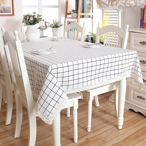 Close-up of black and white checkered tablecloth with delicate wide lace edge decoration