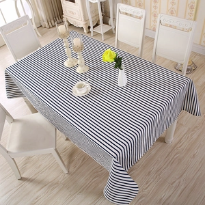 Top view of navy blue and white striped rectangular tablecloth on a dining table