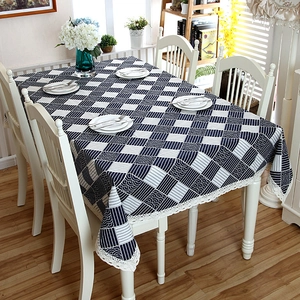 Close-up of black and white checkered cotton table cloth with elegant white lace borders