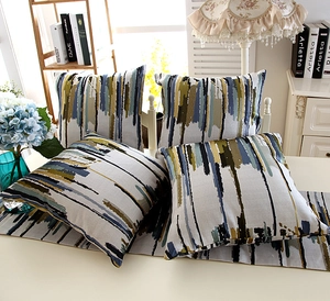 Detail of colorful striped cotton cushions and table runner with abstract art patterns