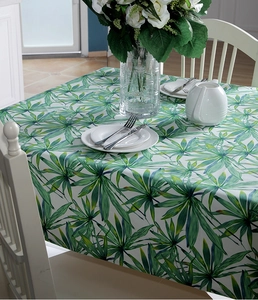 Detail of thick cotton canvas tablecloth with tropical green palm leaf print texture