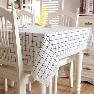 Detail of minimalist plaid tablecloth with elegant lace edges and cotton linen texture