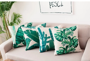 Detailed close-up of tropical palm leaf and cactus prints on cotton linen cushion covers