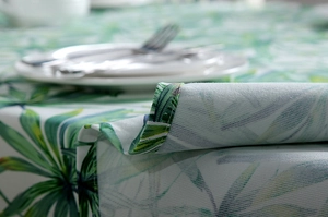 Detailed close-up of thick cotton canvas tablecloth with tropical green leaf patterns