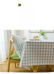 Close-up of blue and white plaid waterproof tablecloth with matching cushions for home decor