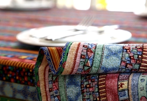 Macro shot of colorful geometric cotton linen tablecloth with premium texture and drape