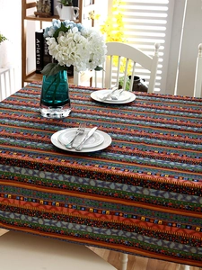 Detailed close-up of Bohemian cotton linen tablecloth with lace edges and ethnic stripes