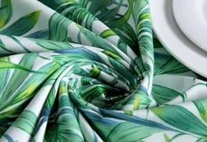 Close-up of thick cotton canvas tablecloth with green tropical palm leaf prints