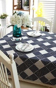 Detailed close-up of navy blue checkered cotton tablecloth with wavy lace edge and wave patterns