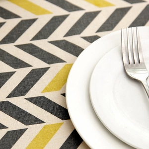 Detail of grey and yellow chevron pattern on textured polyester-cotton blend tablecloth