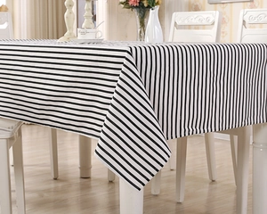 Close-up of black and white striped tablecloth with neat stitching on dining table