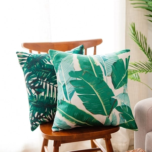 Tropical rainforest leaf print cotton linen cushion covers on wooden chair