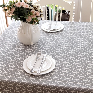 Modern minimalist grey and white geometric arrow pattern tablecloth on dining table