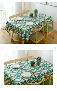 Thick cotton canvas tablecloth with blue and green feather leaf prints in a dining room