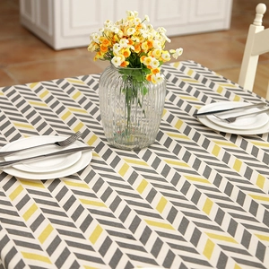 Detailed close-up of modern geometric herringbone pattern on a cotton linen tablecloth