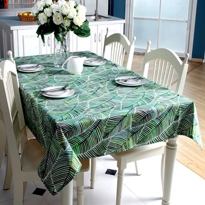 Thick cotton canvas tablecloth with green tropical leaf print on white rectangle fabric