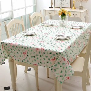 Close-up of tropical flamingo and green palm leaf print on linen blend tablecloth