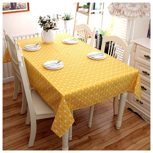 Yellow geometric checkerboard tablecloth on a dining table in a cozy home setting