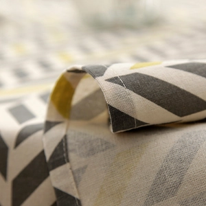 Close-up of geometric triangle pattern on polyester cotton blend fabric with hemmed edge