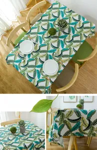 Detail view of cotton leaf pattern tablecloth showing fabric texture and drape on table