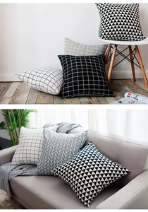 Detail of Nordic style throw pillow covers featuring geometric patterns on a grey sofa