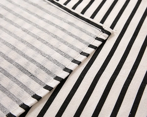 Detailed close-up of striped poly-cotton tablecloth showing fine stitching and fabric texture