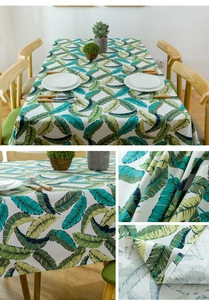 Close-up of thick cotton canvas tablecloth with green tropical banana leaf print pattern