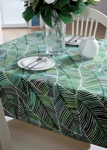 Detailed view of thick cotton canvas tablecloth with green tropical palm leaf print