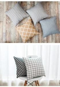 Detail of Nordic geometric cushion covers with hidden zipper on white chair and wood floor