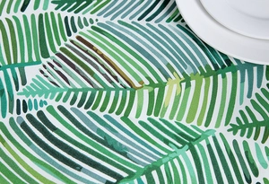 Close-up of thick cotton canvas tablecloth with vibrant tropical green leaf patterns