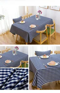 Detail of blue and white checkered tablecloth showing textured weave on wooden table