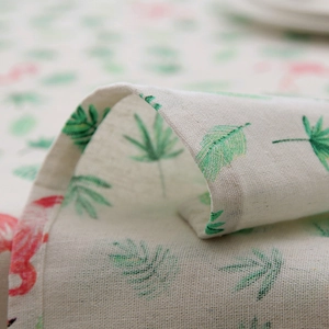 Macro shot of tropical flamingo print on linen texture with neat stitching detail