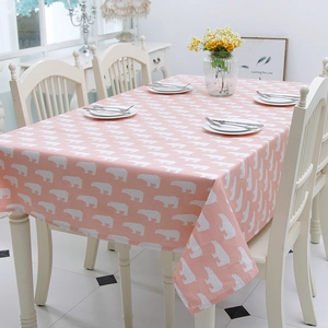 Detailed close-up of pink tablecloth with white polar bear prints and smooth edge stitching