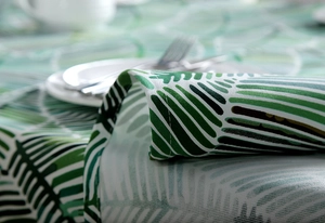 Close-up of tropical palm leaf print canvas tablecloth with premium stitched edge detailing