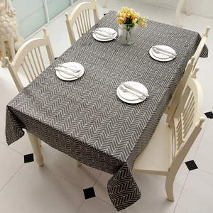 Close-up of modern dark gray tablecloth with white zigzag geometric patterns on fabric
