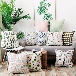 Detailed view of various Nordic plaid and animal print cotton cushion covers on a sofa
