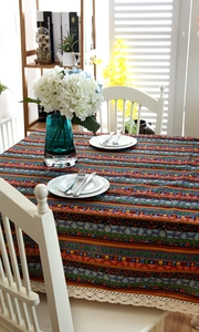 Close-up of Bohemian striped linen tablecloth with exquisite white crochet lace edges