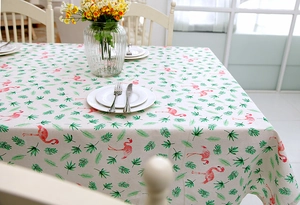 Detailed top view of flamingo and tropical leaf patterns on linen blend tablecloth
