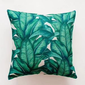 Detailed macro view of tropical banana leaf print on textured cotton linen pillowcase